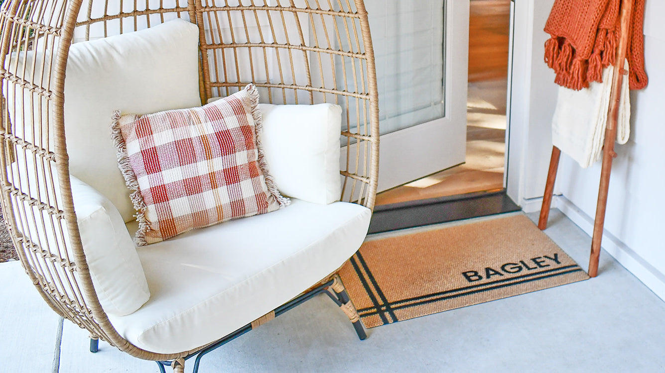 This Hashtag Personalized doormat in a tan color with black text adds a decorative touch to this front porch while providing great floor protection.