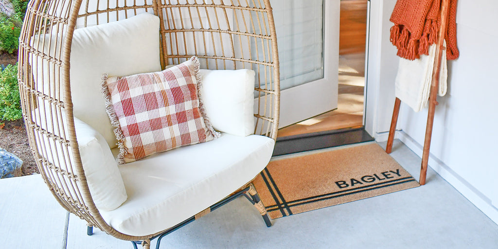 This Hashtag Personalized doormat in a tan color with black text adds a decorative touch to this front porch while providing great floor protection.