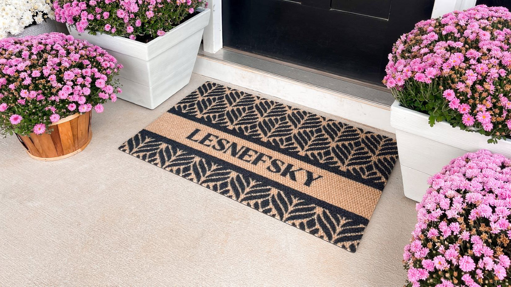 Neighuburly Botanical personalized with a last name on a single sized, indoor doormat with a floral design.