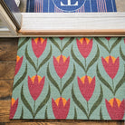 Single door Buttercup Neighburly doormat at the front door of a home paired with a monogrammed mat.