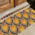 Double door Buttercups floral Neighburly mat protecting the entrance of a home.