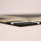 Close-up corner shot of Corner Lot’s low profile and non shedding, black, white, and army surface backed by rubber.