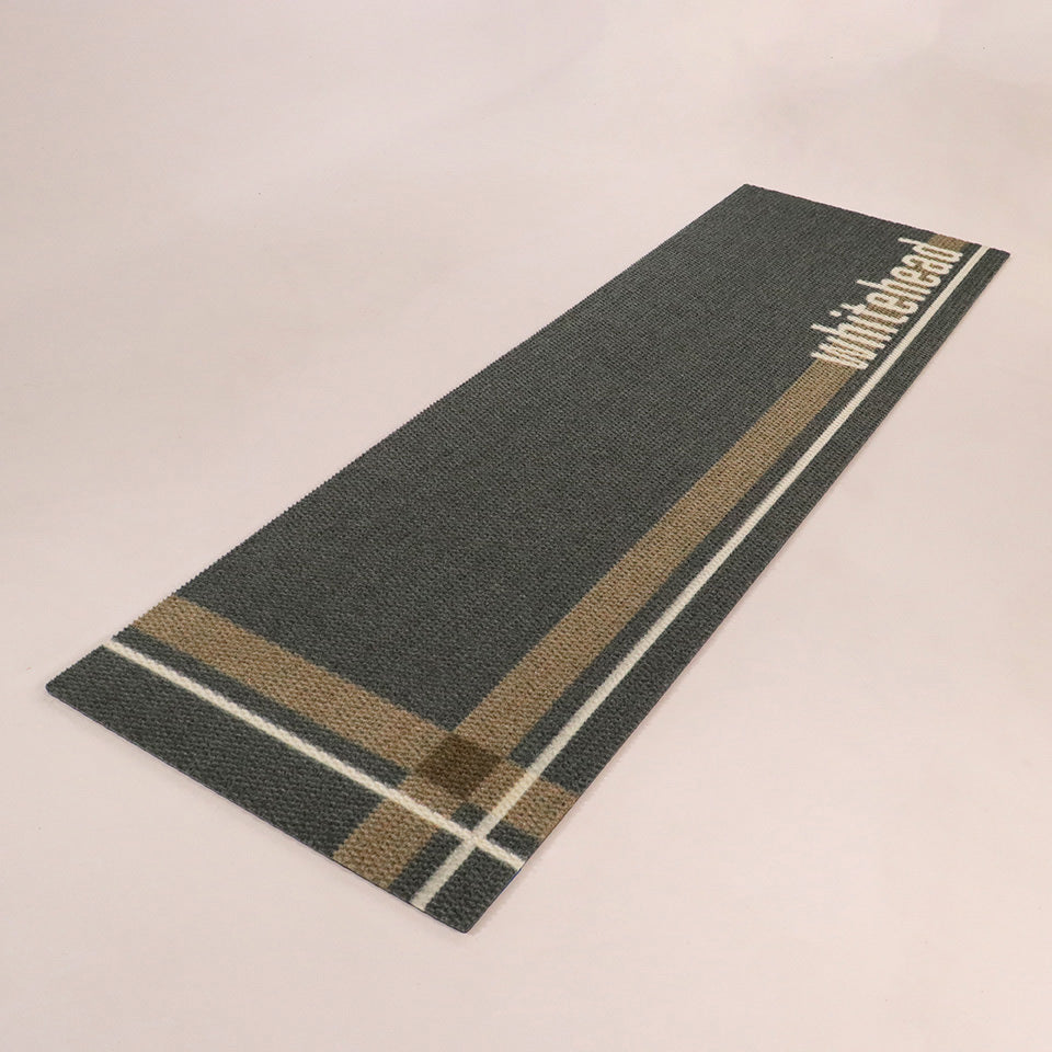 Angled shot of Corner Lot personalized double-sized doormat featuring a last name on army/dark grey/white hashtag design.