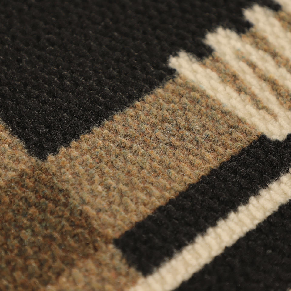 Detailed shot of Corner Lot’s non shedding surface in black, white, and army.
