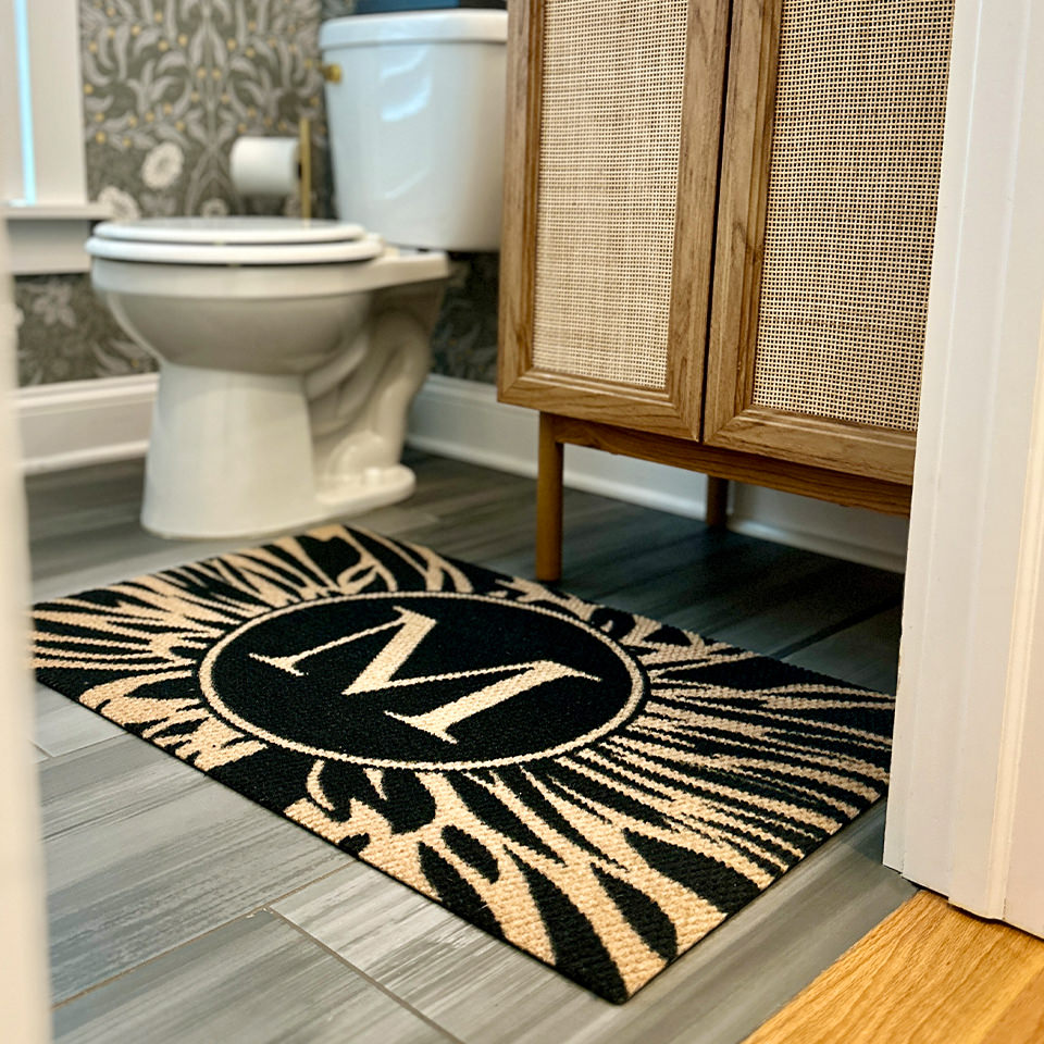 Neighburly's monogramed Dahlia mat in a bathroom; low-profile, no skid, made in the USA.