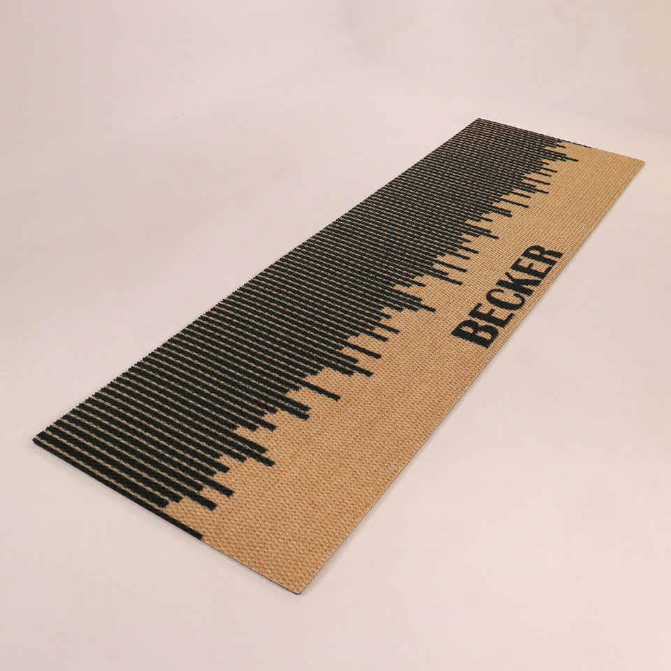 Angled shot of Fall in Line personalized double-sized doormat featuring a last name in black on a black and coir design.