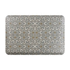 Happy Feet’s Ancient Arabesque anti-fatigue small mat has a blue and white symmetrical design on a grey background.