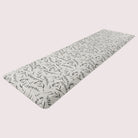 Long anti-fatigue runner perfect for kitchens and bathrooms with botanical black/brown pattern on beige surface.