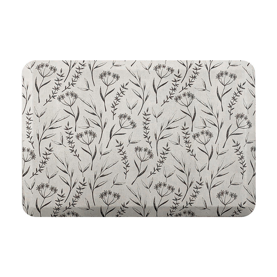 beautiful anti-fatigue mat with brown botanical design on a beige canvas-like textured background.