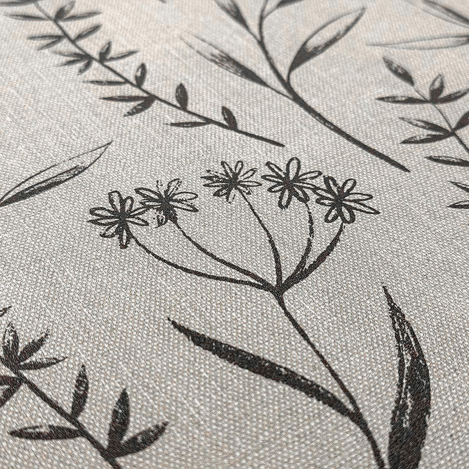 beige canvas-like textured surface with black/brown botanical design.