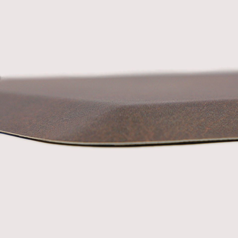 Detailed image of Happy Feet's anti-fatigue Leather mat in the color espresso. The low profile shot highlights the 5/8" thick mat and the beveled edging on a white background.