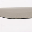Detailed corner image of the anti-fatigue Happy Feet's Linen mat in a soft sand shade. The low profile shot highlights the 5/8" thick mat and the beveled edging on a white background.