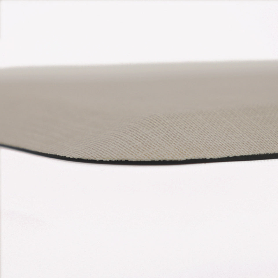 Detailed corner image of the anti-fatigue Happy Feet's Linen mat in a soft sand shade. The low profile shot highlights the 5/8" thick mat and the beveled edging on a white background.