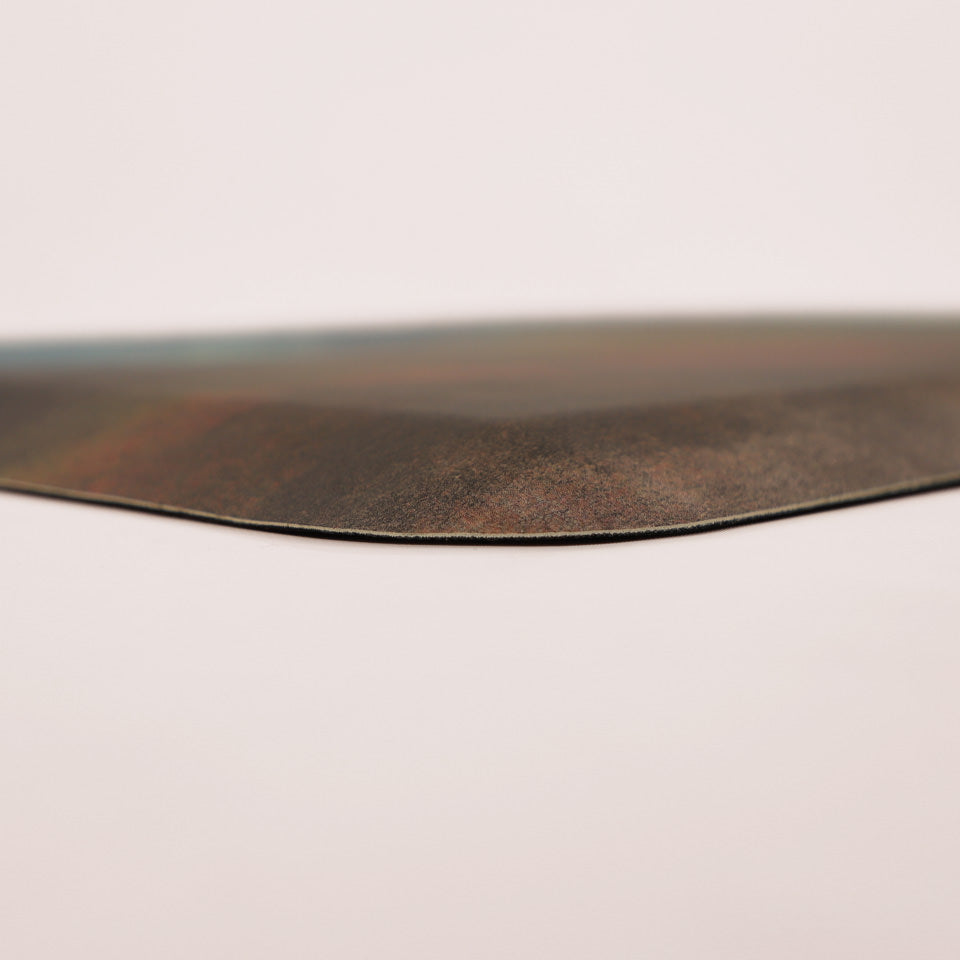 Corner shot of Happy Feet's Patina mat design, high-definition print, wipeable surface, and beveled edges.
