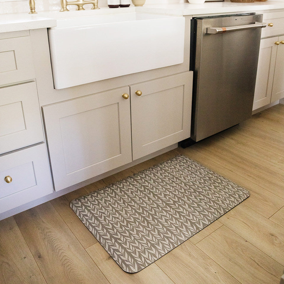 Variegated Vine anti-fatigue mat in grey with a white pattern on a light oak kitchen floor
