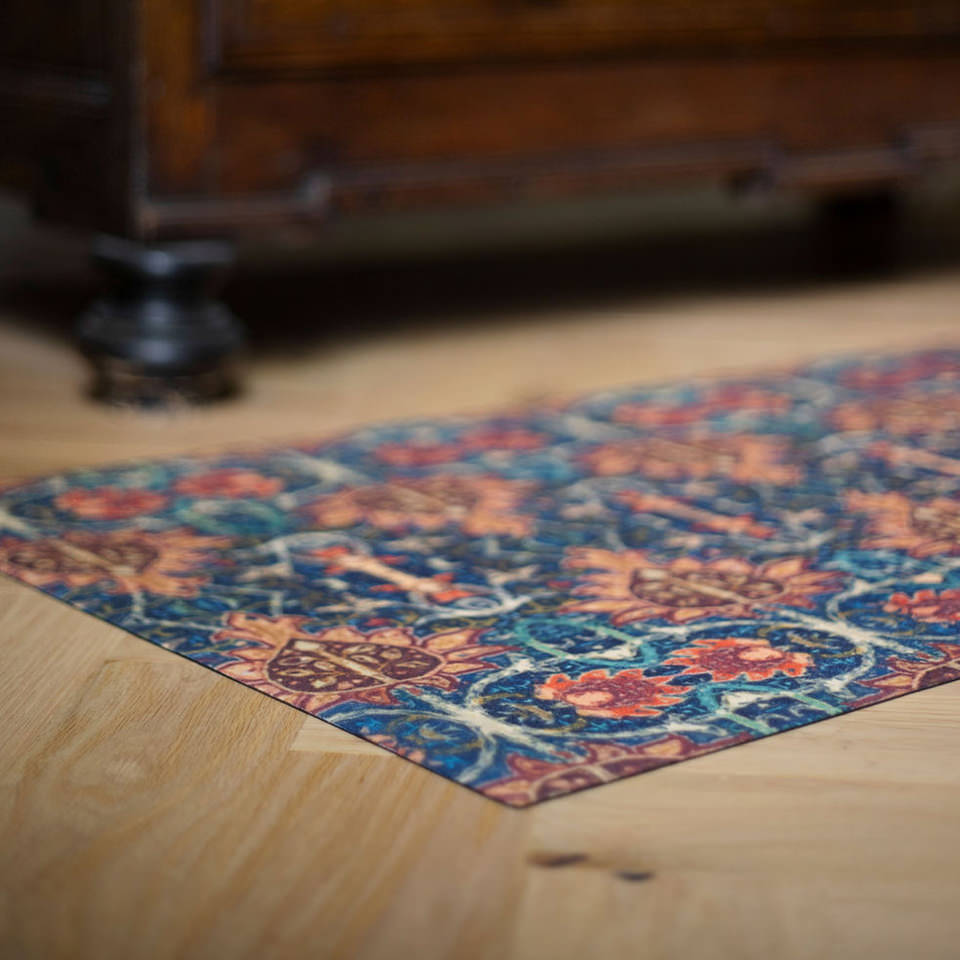 Close up images of the Persian Un-Rug's incredibly low-profile and vibrant printed surface of blues, oranges, and creams, on a soft knitted surface.