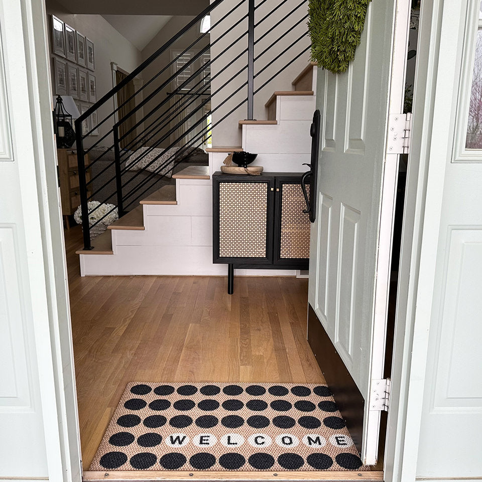 Lucky Numbers personalized with welcome with the low-profile mat under an open door.