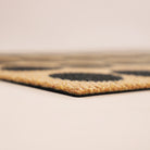 Close up corner shot of Lucky Numbersin black, white, and coir no shedding and rubber backing.