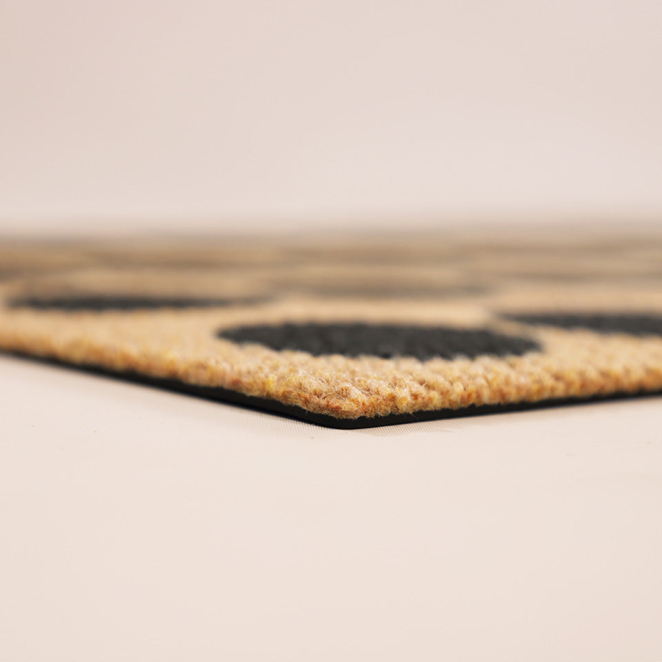 Close up corner shot of Lucky Numbersin black, white, and coir no shedding and rubber backing.