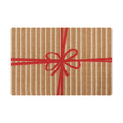 Cute holiday themed door mat that looks like a brown and white striped present with red bow.