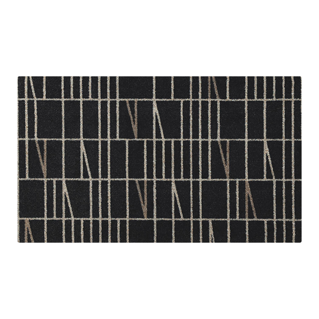 Isolated overhead image of Maxcent Biblioteca accent mat in charcoal with ivory geometric grid pattern—modern, washable, and low-profile floor mat.