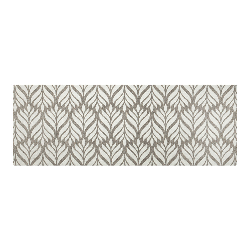 "Maxcent Botanica runner mat in Light Greige – a long rectangular rug with a cream leaf pattern layered over a soft brown-gray background. The subtle contrast adds a touch of elegance to narrow spaces like hallways or kitchens. Designed with a cushioned carpeted surface and non-slip rubber backing for comfort and stability.
