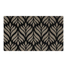 Overhead view of Maxcent Botanica accent mat in space grey with dramatic black leaf pattern—modern botanical motif with durable mat performance.