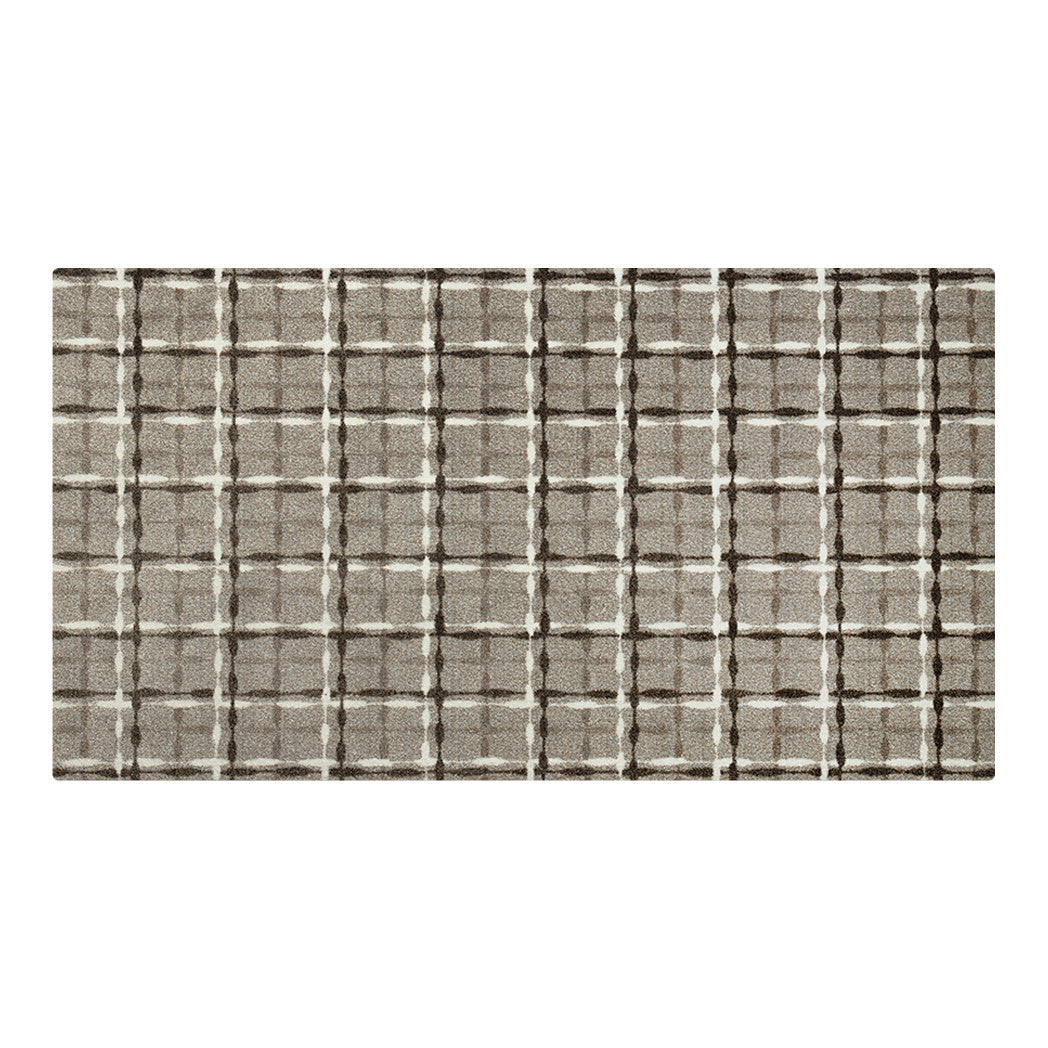 Maxcent Heritage Tweed area mat in Light Greige, medium size – features a warm beige/grey background with a crosshatch pattern in dark brown and off-white. The soft, woven-look surface adds comfort and subtle texture, while the non-slip rubber backing ensures stability on hard floors.