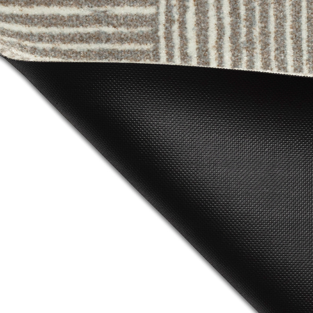 Detail view of the Maxcent Organic Squares floor mat with corner flipped to reveal the non-slip rubber backing, designed for stability, floor protection, and everyday durability.