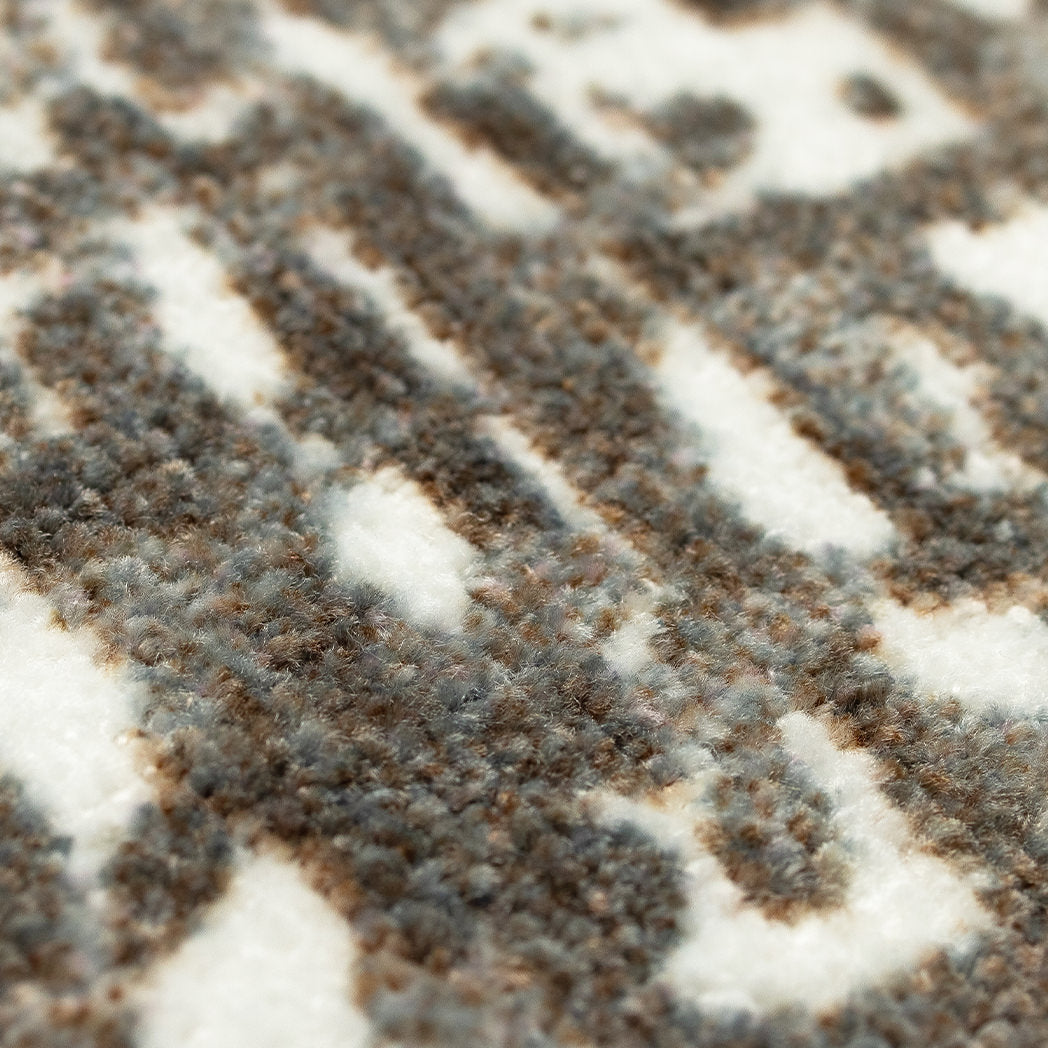 Close-up view of Maxcent Stone Weave rug-mat hybrid showing soft, high-pile textured fibers in a modern abstract brown and beige design — durable, cozy, and perfect for high-traffic indoor areas.
