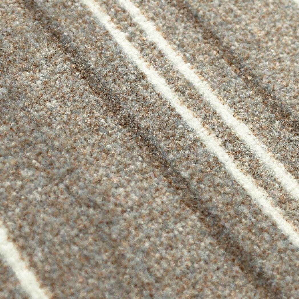 Close-up of the Maxcent Ticking Stripes mat, showcasing its soft textured surface in warm beige and cream tones with narrow accent stripes for a classic, tailored look.
