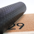 Close up of rubber backing on Modern Main personalized house number doormat in tan and black