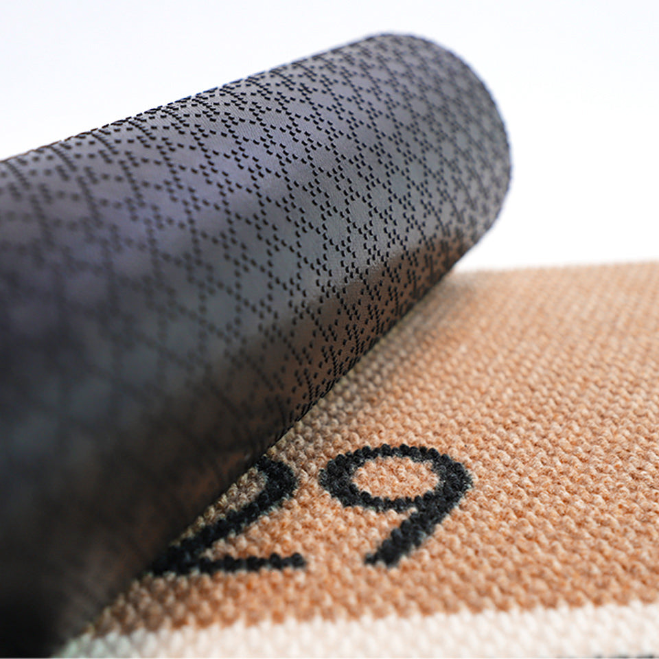 Close up of rubber backing on Modern Main personalized house number doormat in tan and black