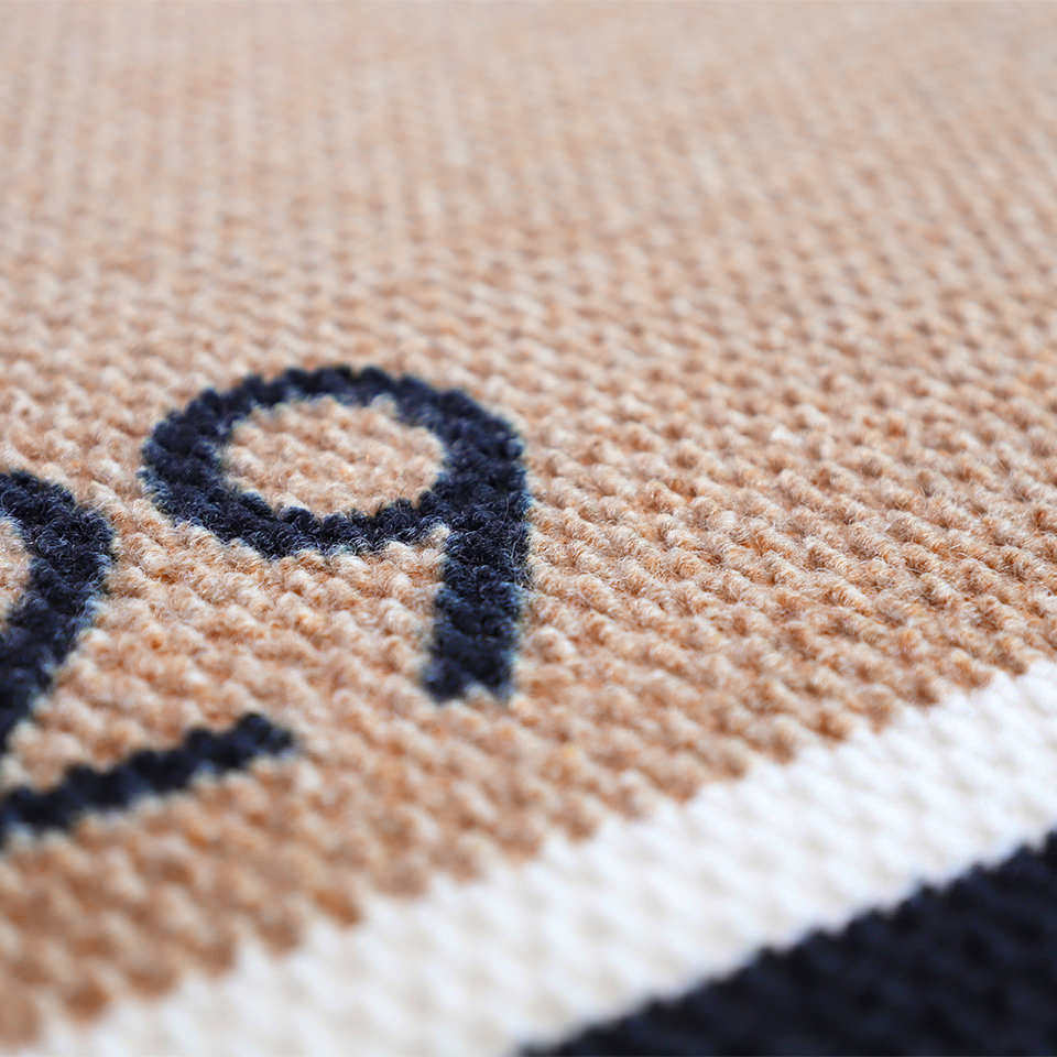 Close up of non shedding fibers on Modern Main personalized house number doormat