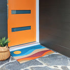 Neighburly's Mountain Sunset abstract imagery in front of a orange door that matches the orange in the mat.