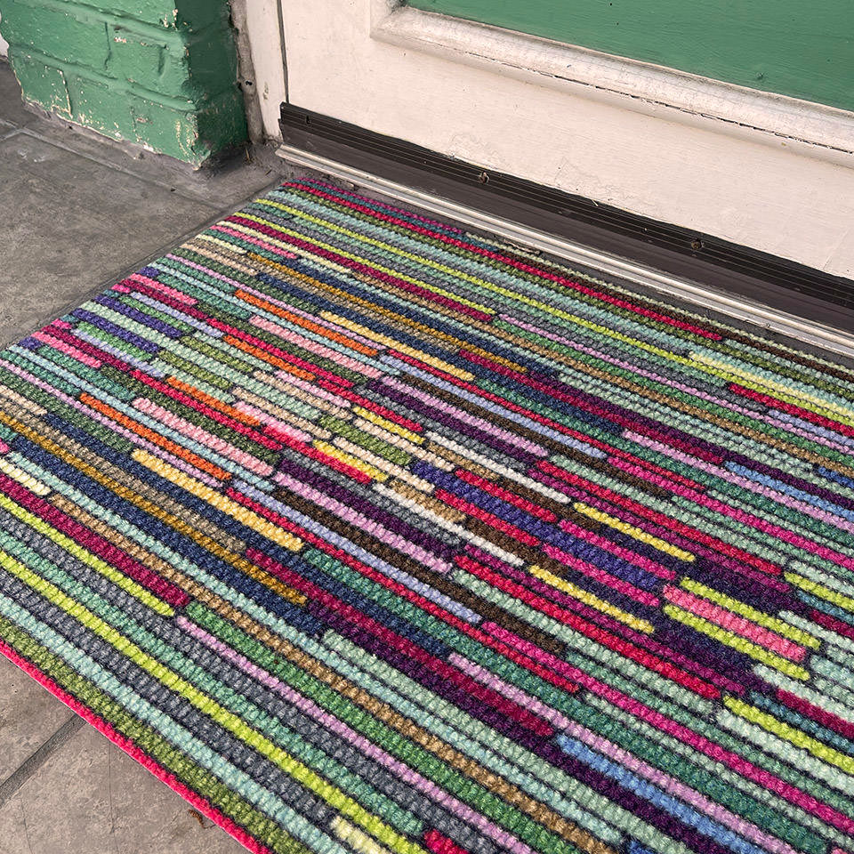 closeup of dutch fields horizontal mat outside front entryway