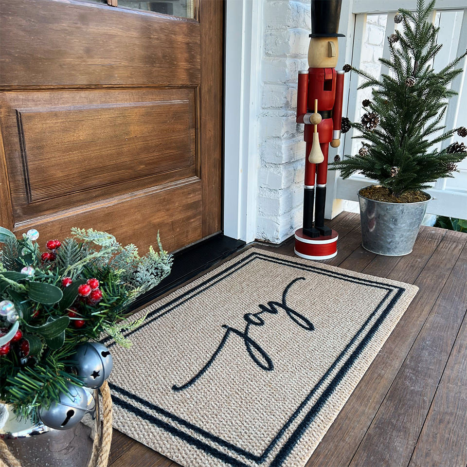 Surname Script personalized with the saying Joy with Christmas decoration surrounding the mat and door.