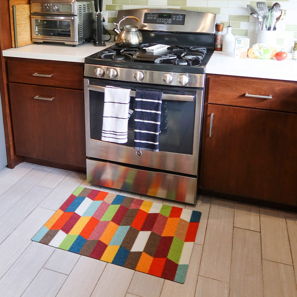 Low-profile Colorful Tulips single door mat in a kitchen in front of an oven for floor protection.
