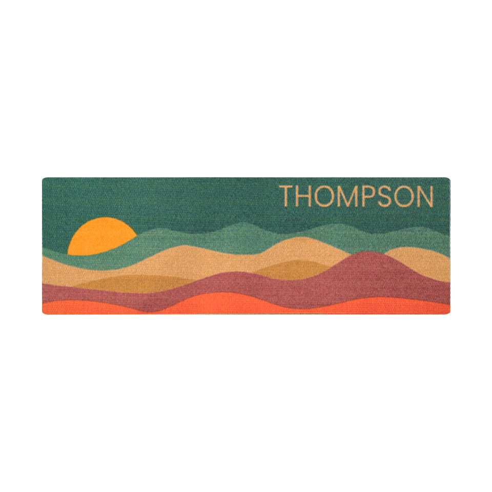 Overhead double door Personal Sunset mat with last name in vibrant colors of aquas, coir, maroon, orange, and yellow.