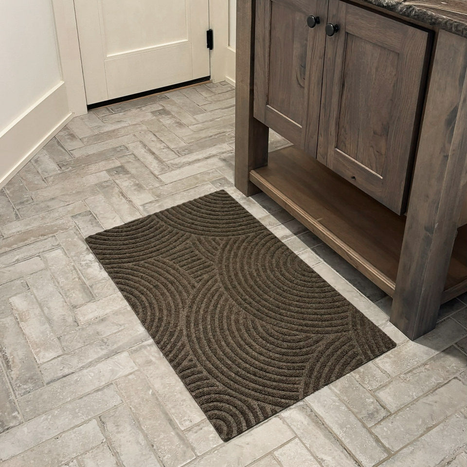 WaterHog Luxe's Put Your Records On single door mat in front of a bathroom vanity protecting the floors