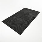 WaterHog Luxe Put Your Records On circular geometric patterned doormat for single door at an angle.