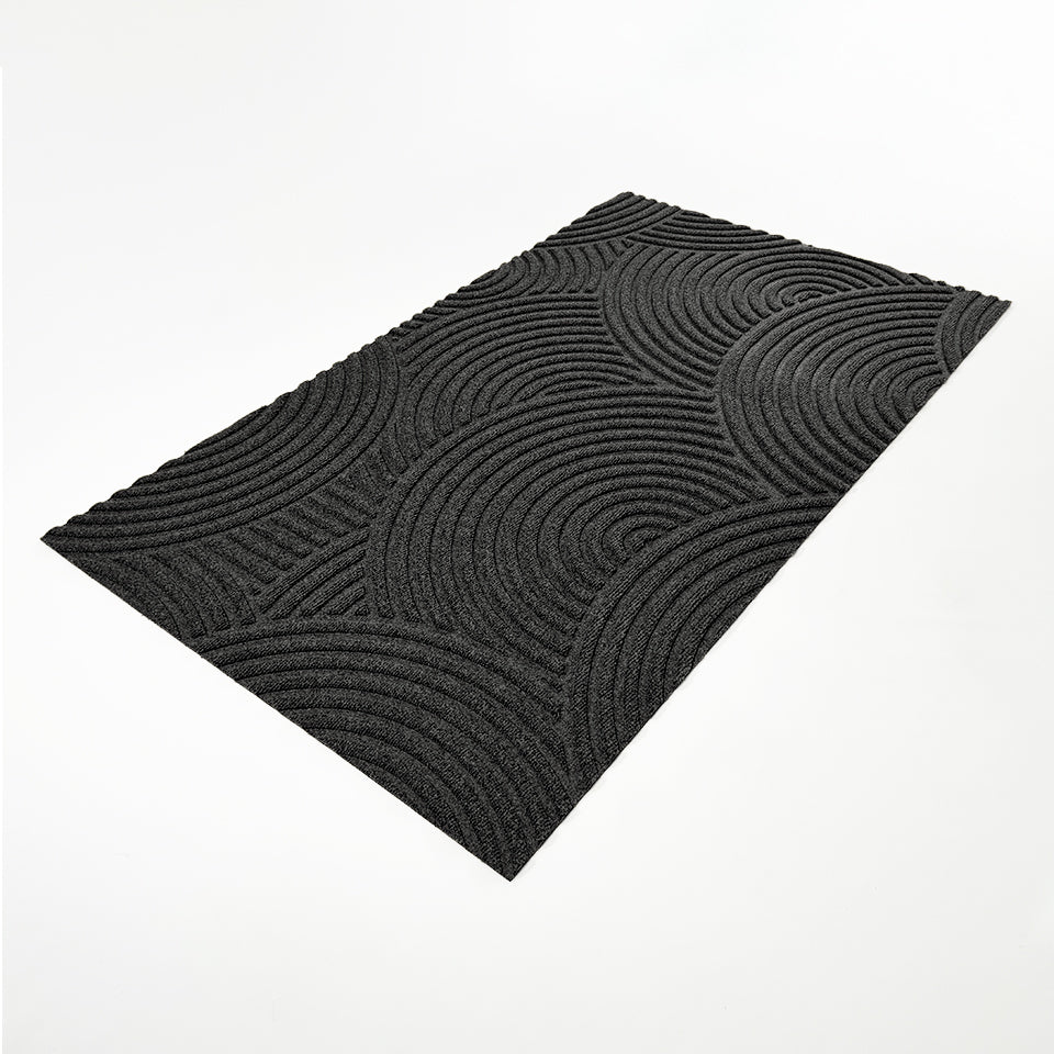 WaterHog Luxe Put Your Records On circular geometric patterned doormat for single door at an angle.