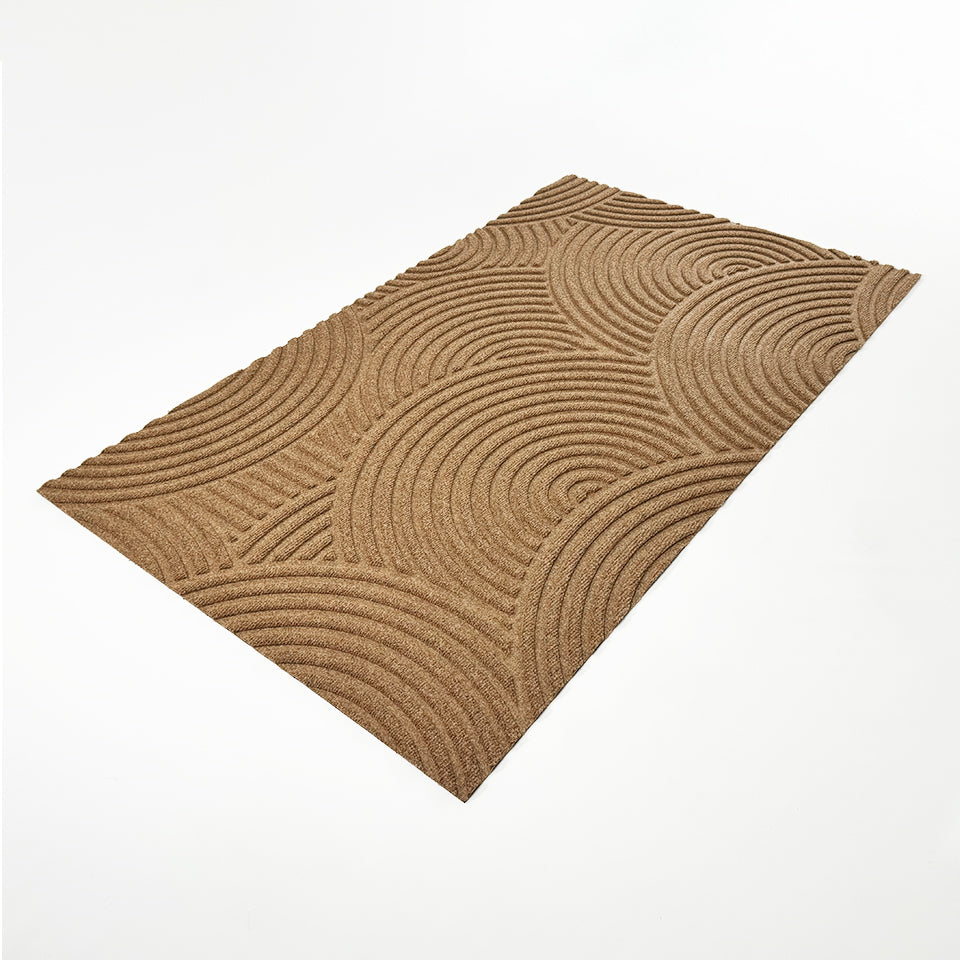 WaterHog Luxe Put Your Records On circular geometric patterned wheat doormat in large at an angle.