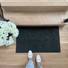 WaterHog Luxe Put Your Records On in single door graphite at the bottom on a staircase protecting the floors.