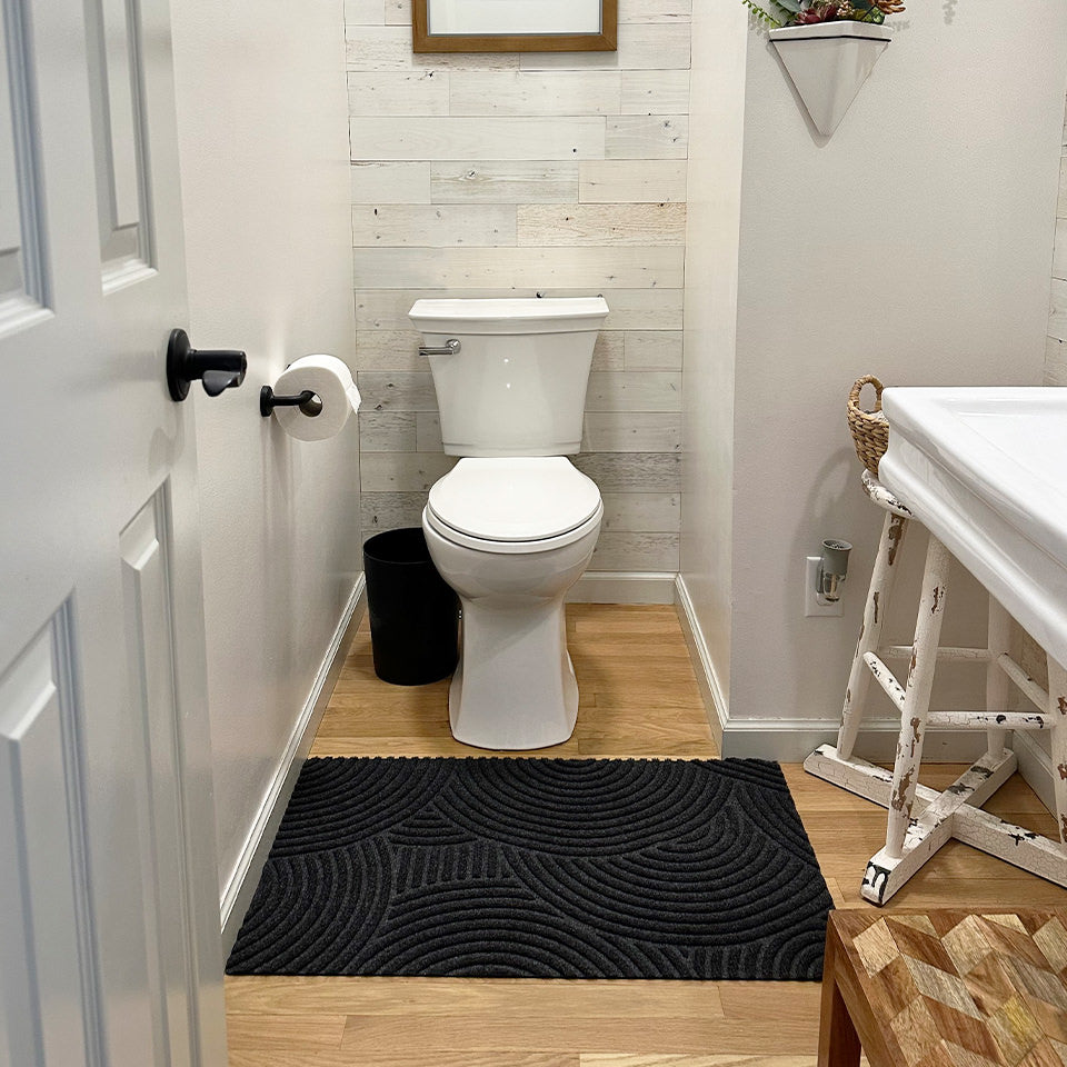 WaterHog Luxe Put Your Records On low-profile bathroom mat protecting the bathroom floors from toilet and sink use.