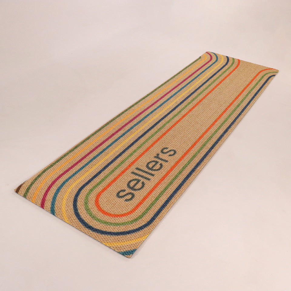 Angled shot Rainbow Roundabout double door personalized with a name within oval lines of oranges, greens, blues, yellow, and maroon.