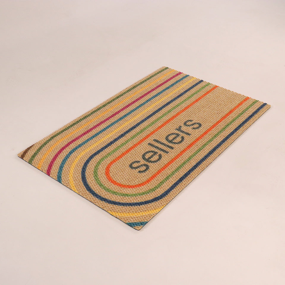 Angled shot Rainbow Roundabout single door personalized with a name within oval lines of oranges, greens, blues, yellow, and maroon.