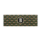 Spring Blooms double door monogrammed doormat in green, yellow and black shown on a covered porch by the front door.