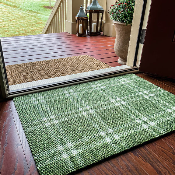 Green plaid doormat at front door paired with wheat colored outdoor doormat
