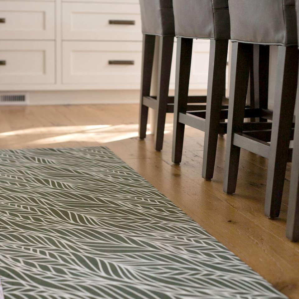 Abstract cream colored leaf pattern on medium olive green linen look low profile washable floormat